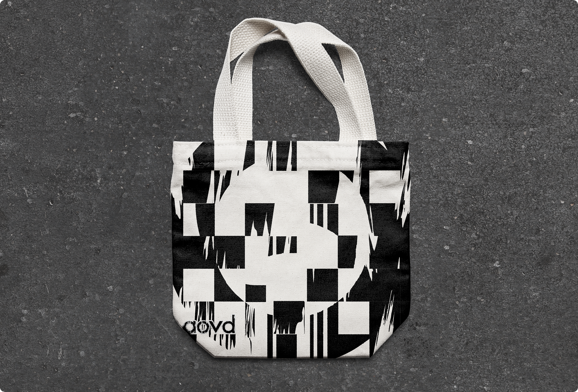 Tote bag with a modified lowercase 'a' in the AoVD: English typeface.