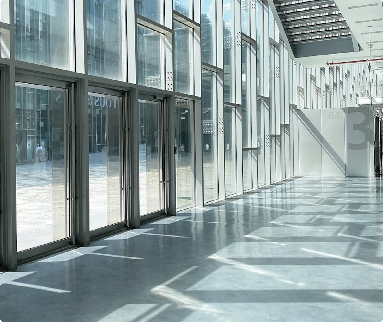 Glass wall with steel frames from within Arthouse MOMO.